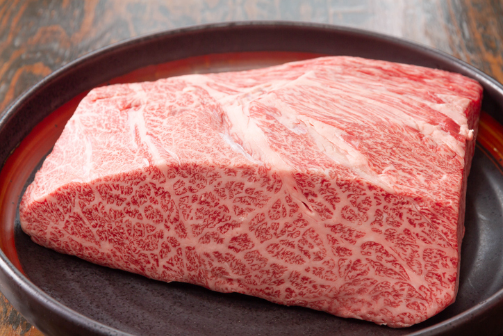 A raw steak heavily marbled with fat.